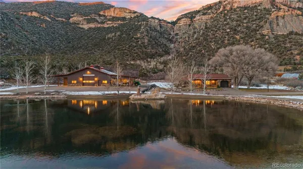 a view of residential houses with outdoor space and river