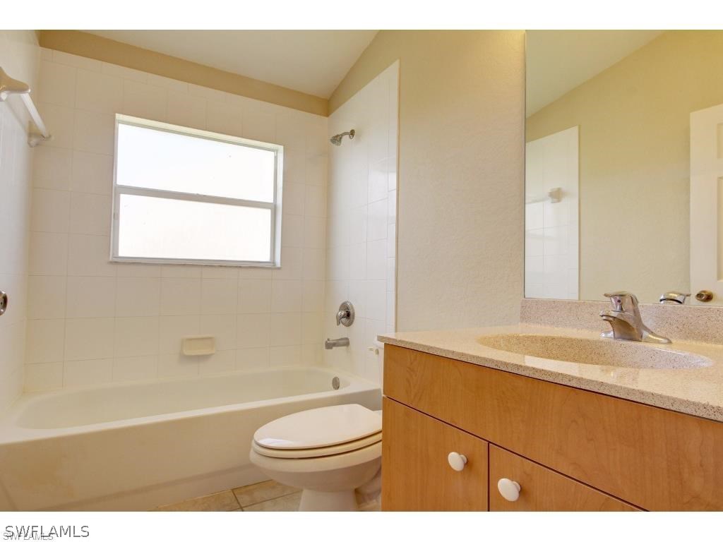 101 West 12th Street Lehigh Acres, FL 33972 - Photo 6 of 7 a bathroom with a sink a toilet and a bathtub