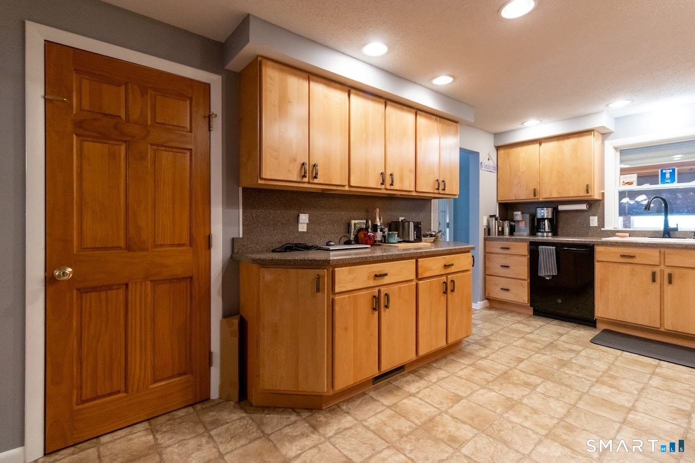 763 North Street Suffield, CT 06078 - Photo 11 of 40 a kitchen with stainless steel appliances granite countertop a refrigerator a sink dishwasher and wooden cabinets