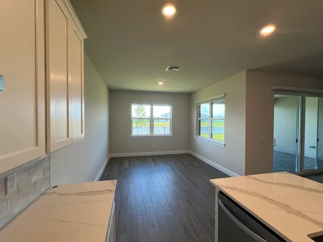 a kitchen with a wooden floor and window