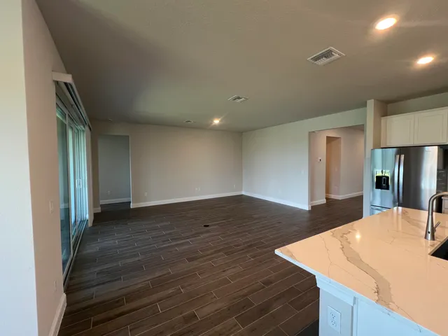 a view of kitchen island with cabinets and wooden floor