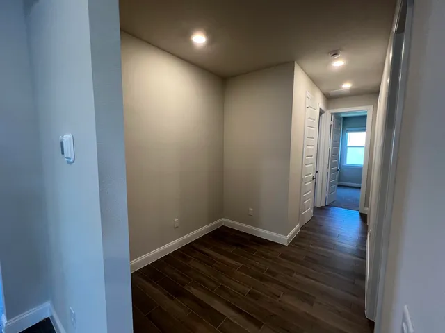 a view of hallway with wooden floor