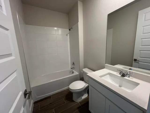 a bathroom with a sink toilet tub and shower