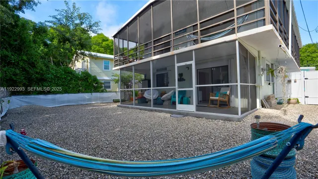 an aerial view of a house with a yard and green space