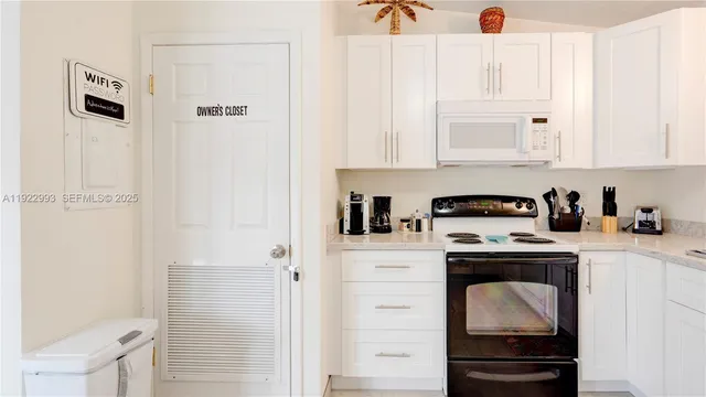 a bedroom with a bed and a flat tv screen on the dresser