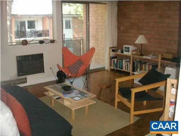 a living room with a couch a dining table and chairs