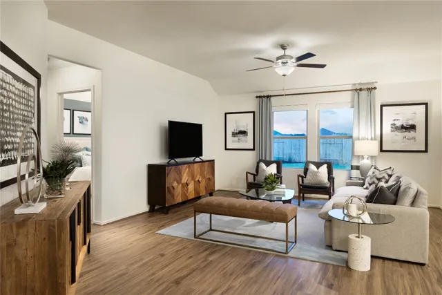 a living room with furniture and a flat screen tv