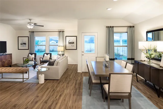 a dining room with furniture a chandelier and wooden floor