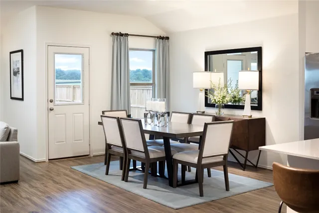 a dining room with furniture and wooden floor