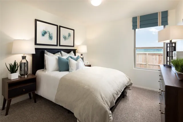 a bedroom with a bed and a night stand