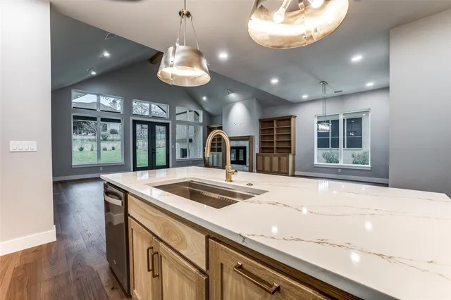 a kitchen with a stove and a wooden floor
