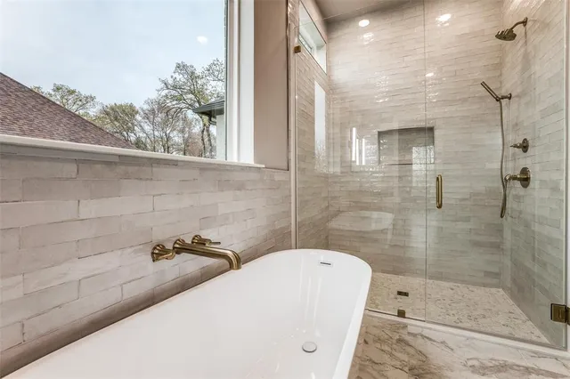 a bathroom with a tub and a shower