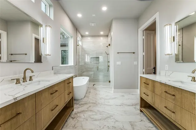 a spacious bathroom with a double vanity sink mirror double and shower