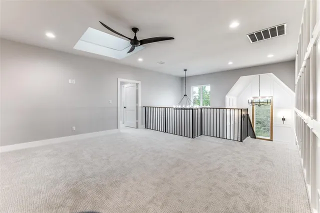 an empty room with large windows and stairs