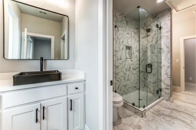 a bathroom with a shower sink and mirror