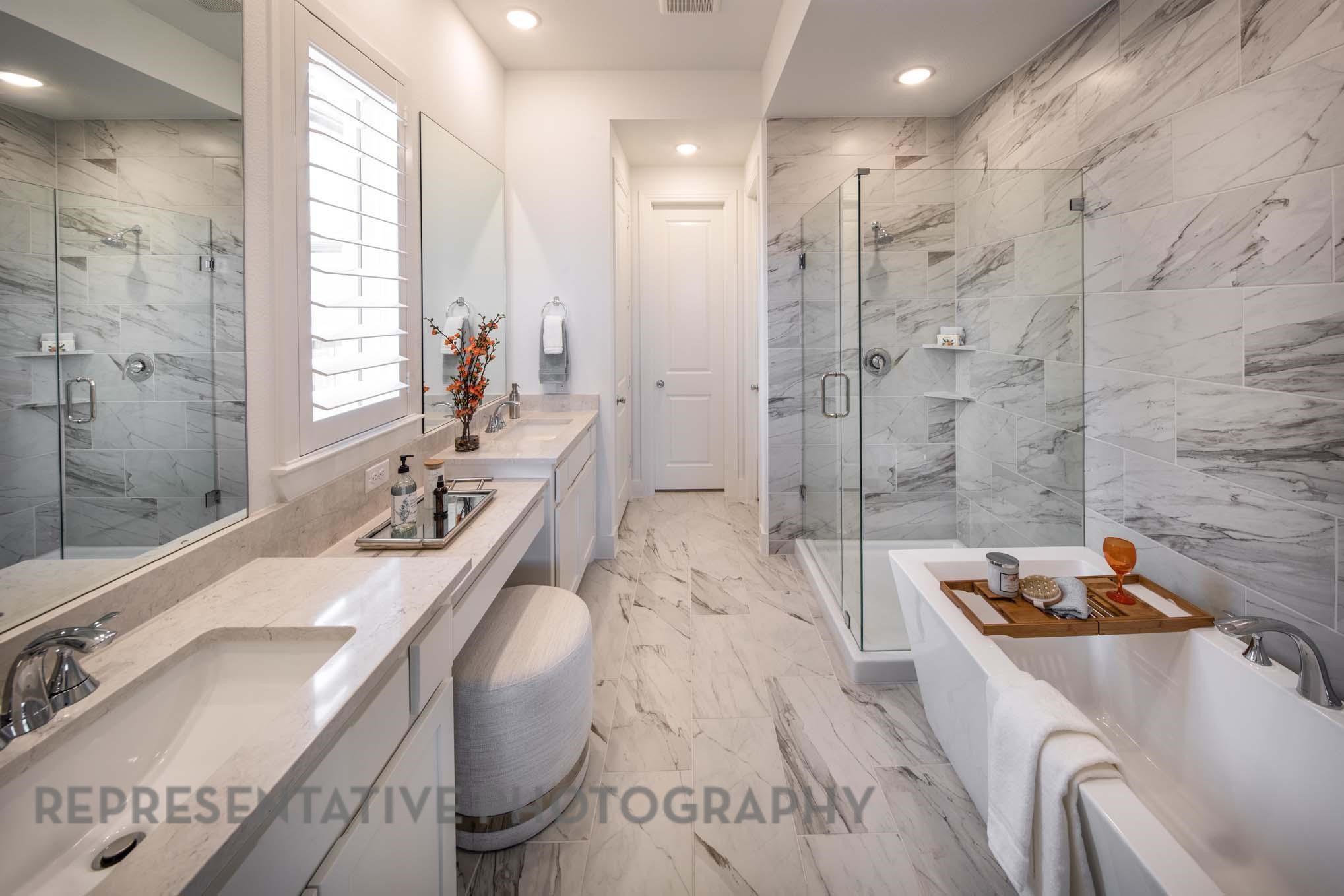 22210 Mount Whitney Road Waller, TX 77484 - Photo 14 of 29 a bathroom with a granite countertop double vanity sink a bathtub and shower