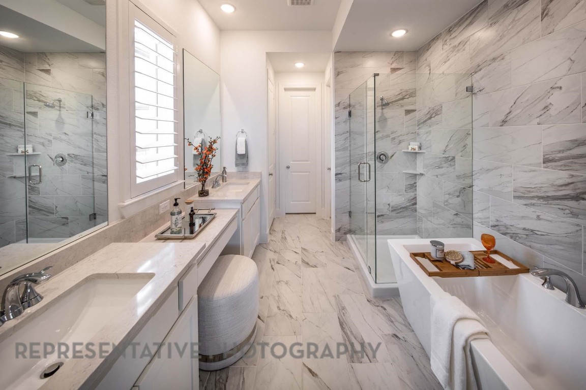 22210 Mount Whitney Road Waller, TX 77484 - Photo 14 of 29 a bathroom with a granite countertop double vanity sink a bathtub and shower