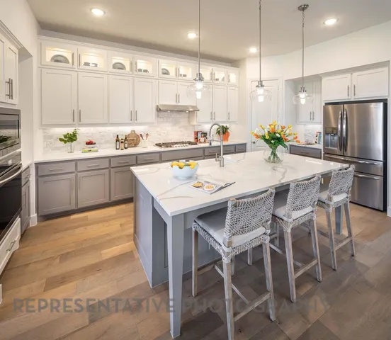 a kitchen with kitchen island granite countertop a table and chairs in it
