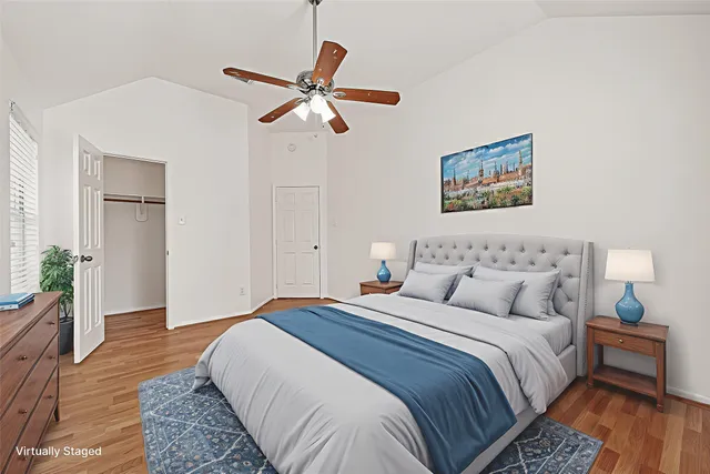 a bedroom with bed and wooden floor
