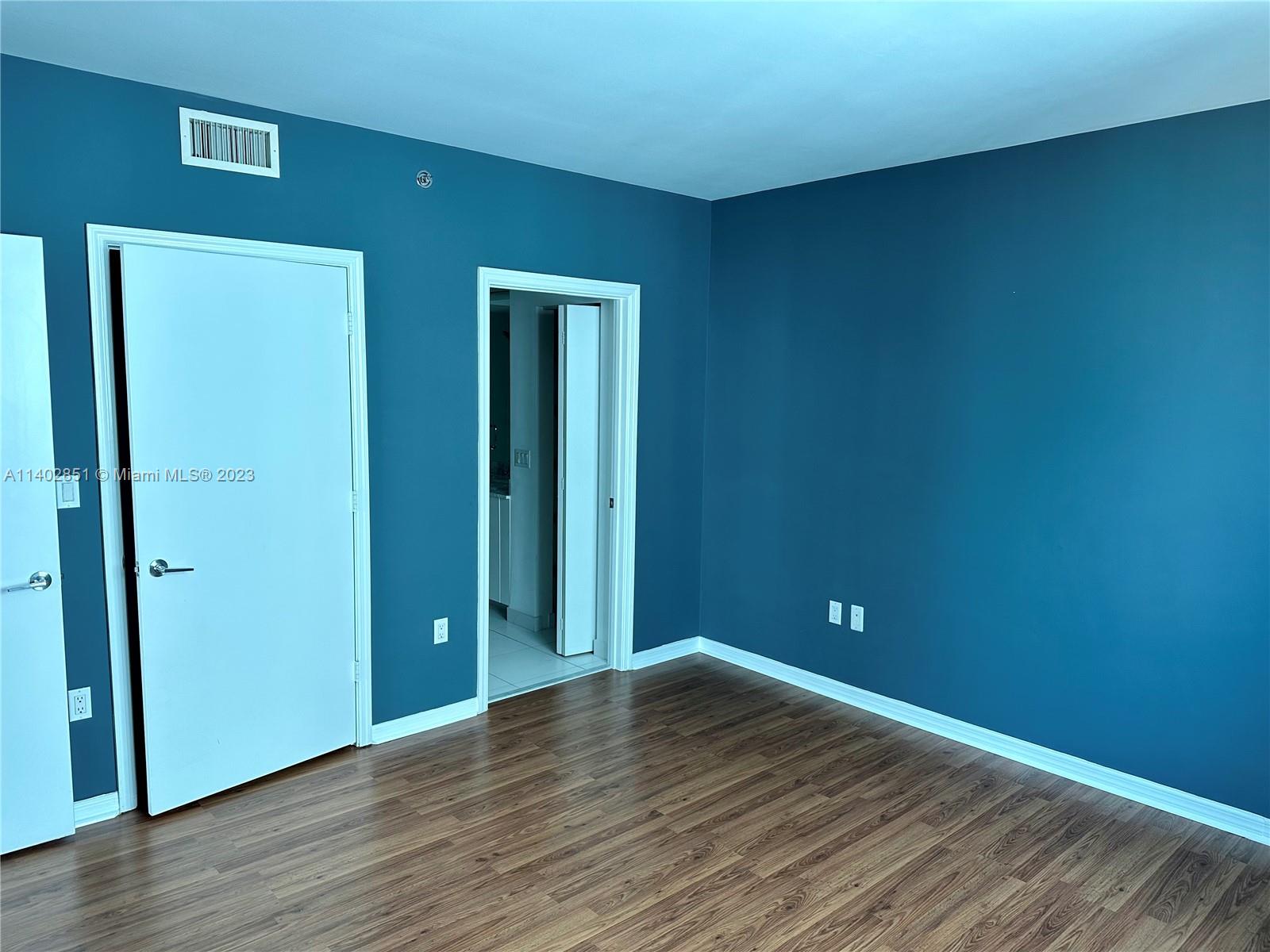 500 Brickell Avenue, Unit 2007 Miami, FL 33131 - Photo 16 of 31 a view of an empty room with wooden floor and closet