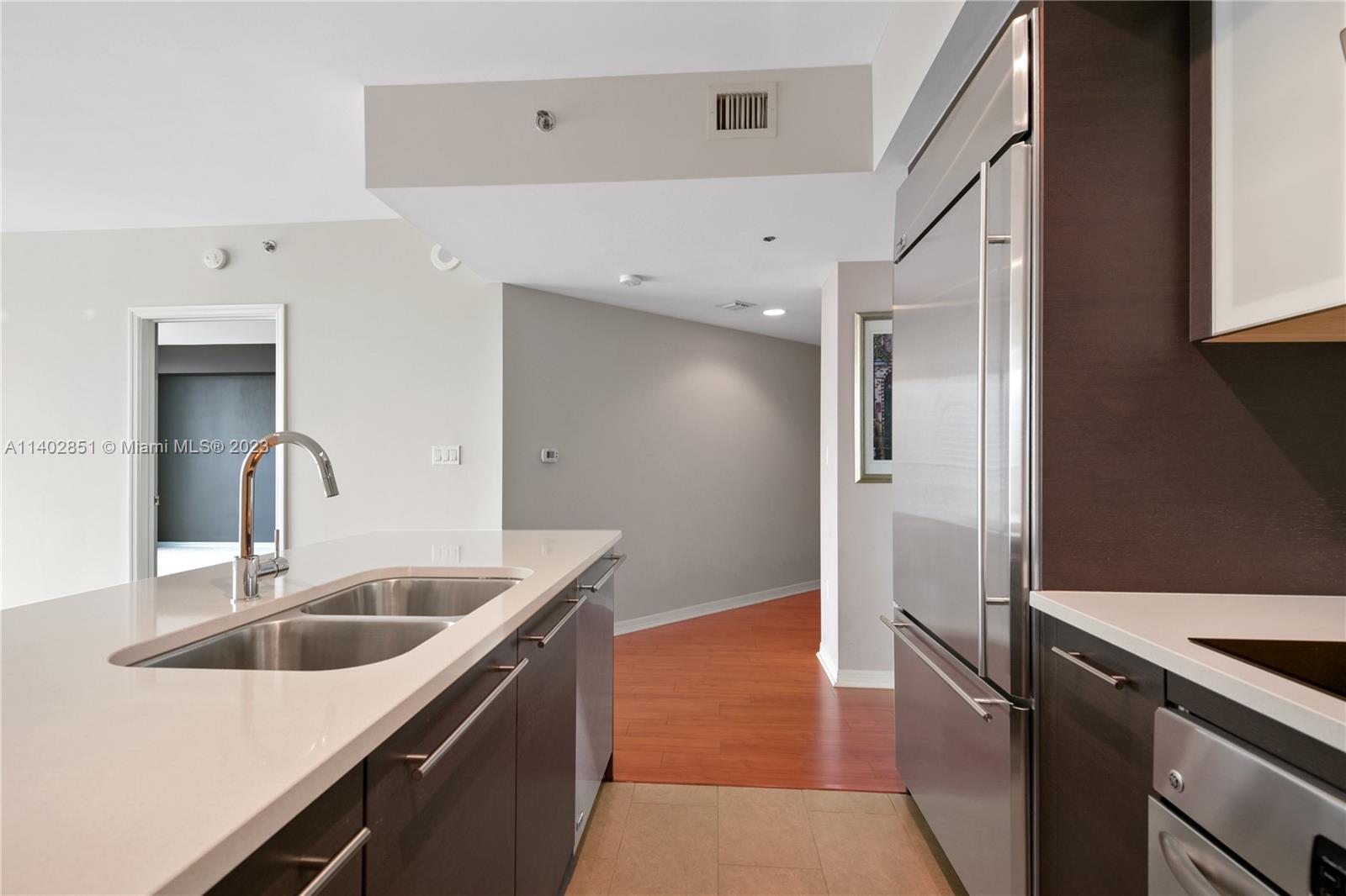 500 Brickell Avenue, Unit 2007 Miami, FL 33131 - Photo 4 of 31 a kitchen with a sink and refrigerator