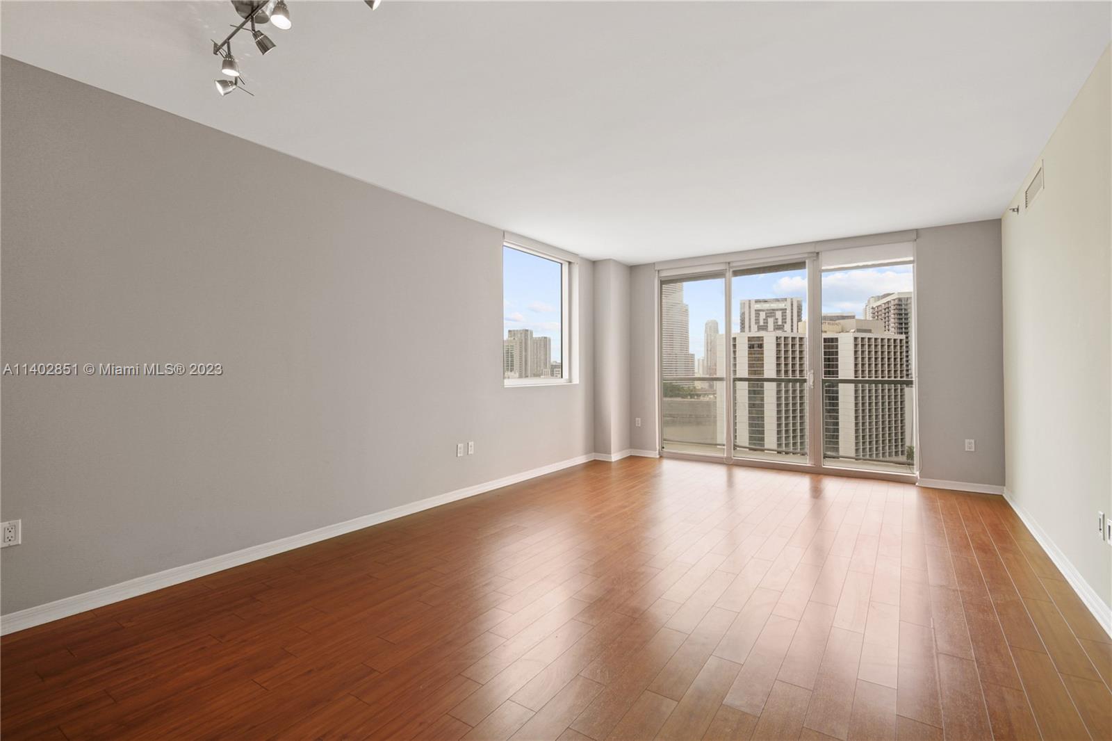 500 Brickell Avenue, Unit 2007 Miami, FL 33131 - Photo 7 of 31 a view of an empty room with wooden floor and a window