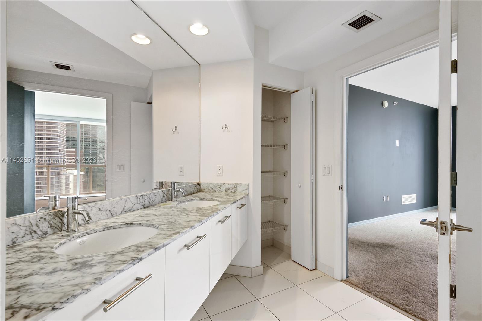 500 Brickell Avenue, Unit 2007 Miami, FL 33131 - Photo 10 of 31 a bathroom with a granite countertop sink and a mirror