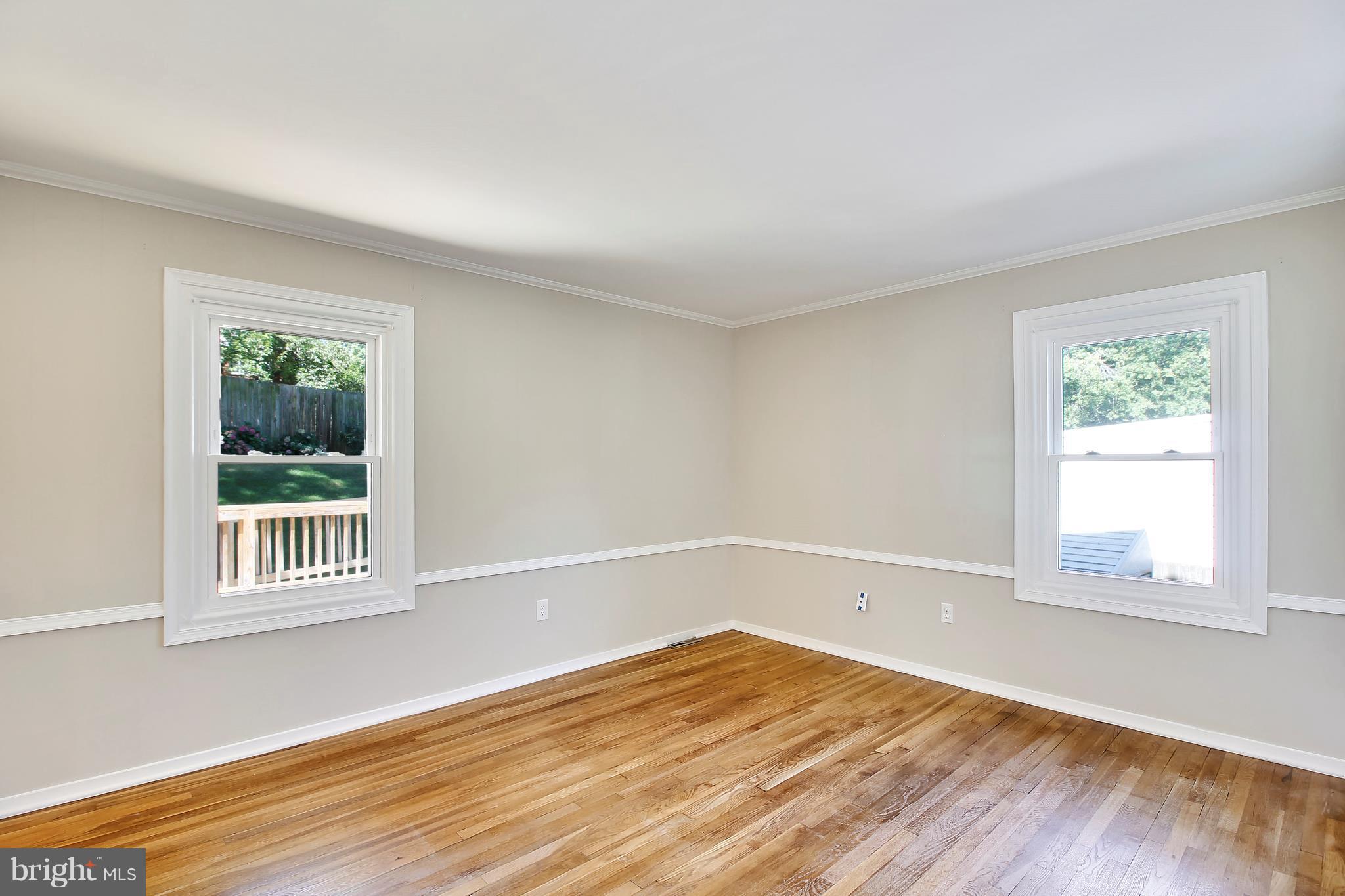 13106 Estelle Road Silver Spring, MD 20906 - Photo 11 of 21 a view of an empty room with wooden floor and a window
