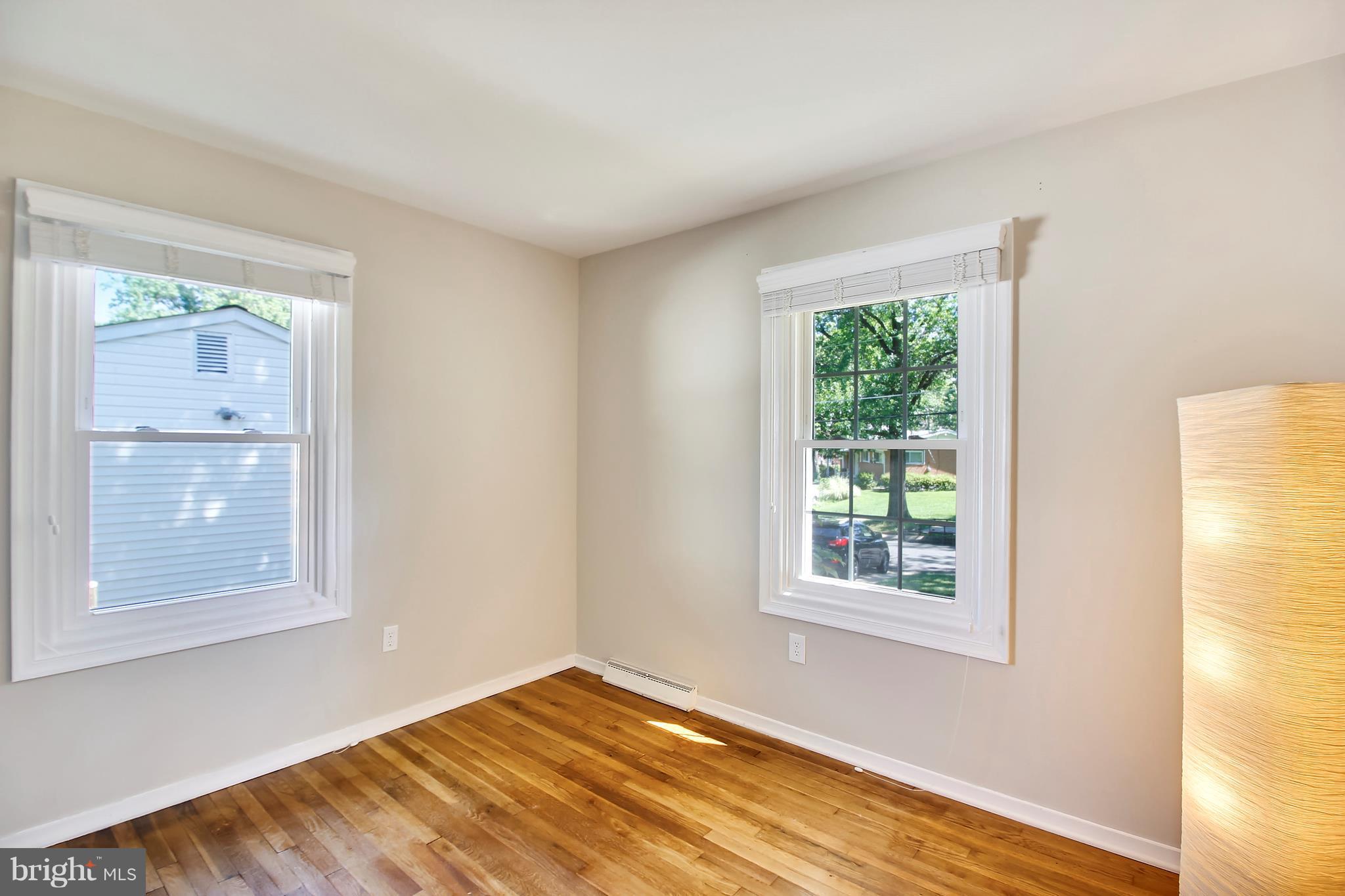 13106 Estelle Road Silver Spring, MD 20906 - Photo 13 of 21 a view of an empty room with wooden floor and a window