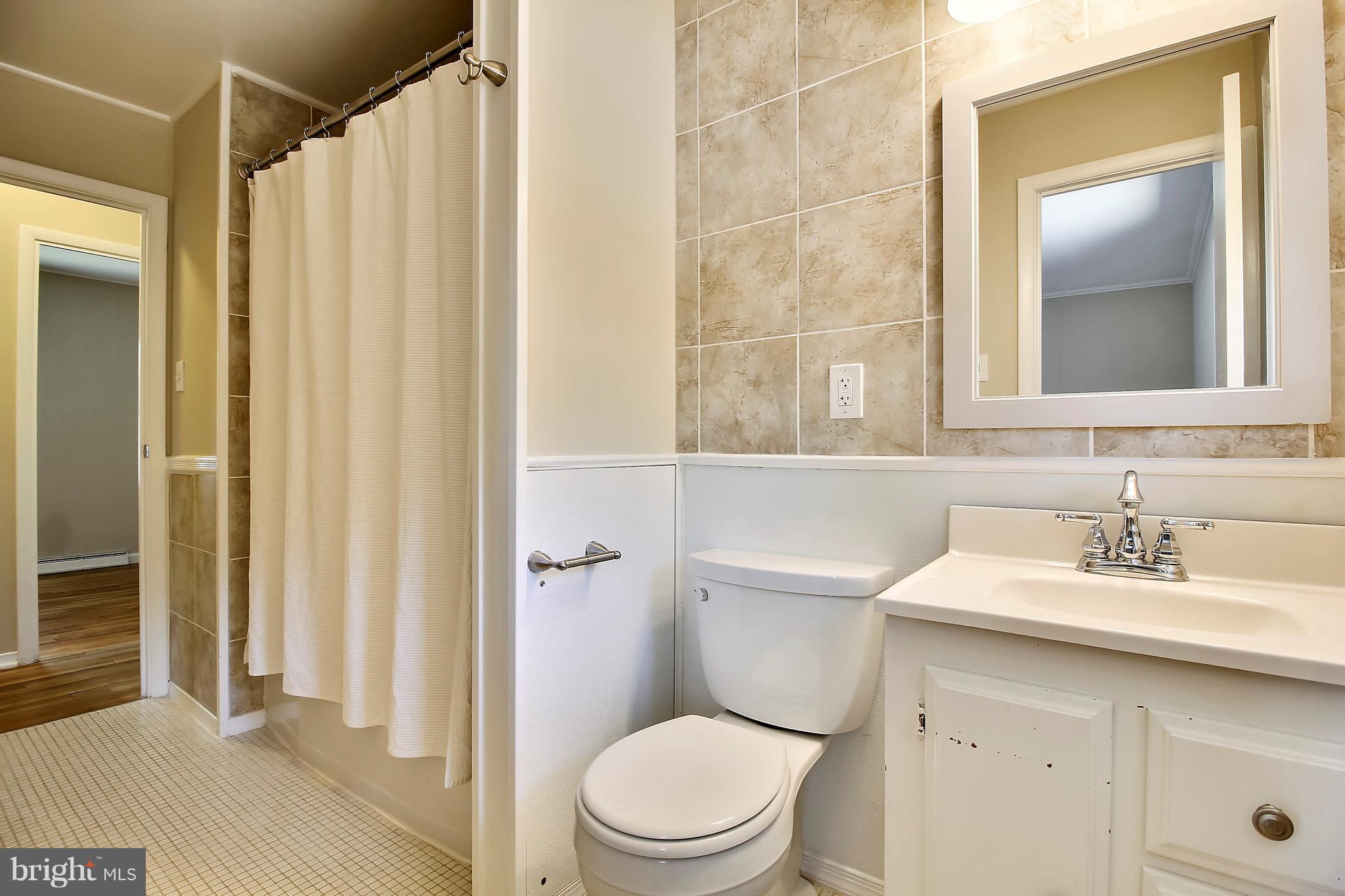 13106 Estelle Road Silver Spring, MD 20906 - Photo 15 of 21 a bathroom with a sink a toilet and shower