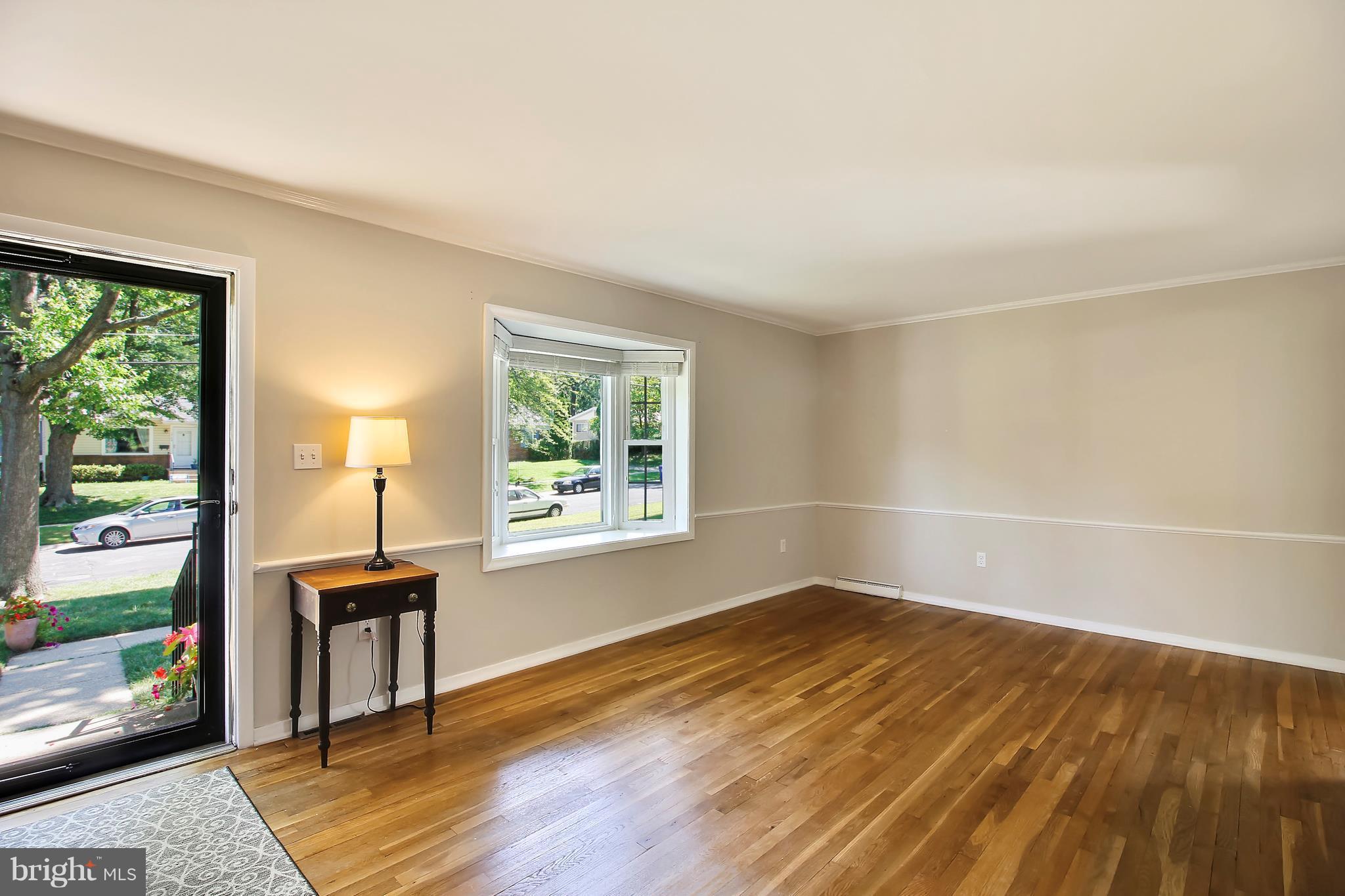 13106 Estelle Road Silver Spring, MD 20906 - Photo 4 of 21 an empty room with wooden floor and windows