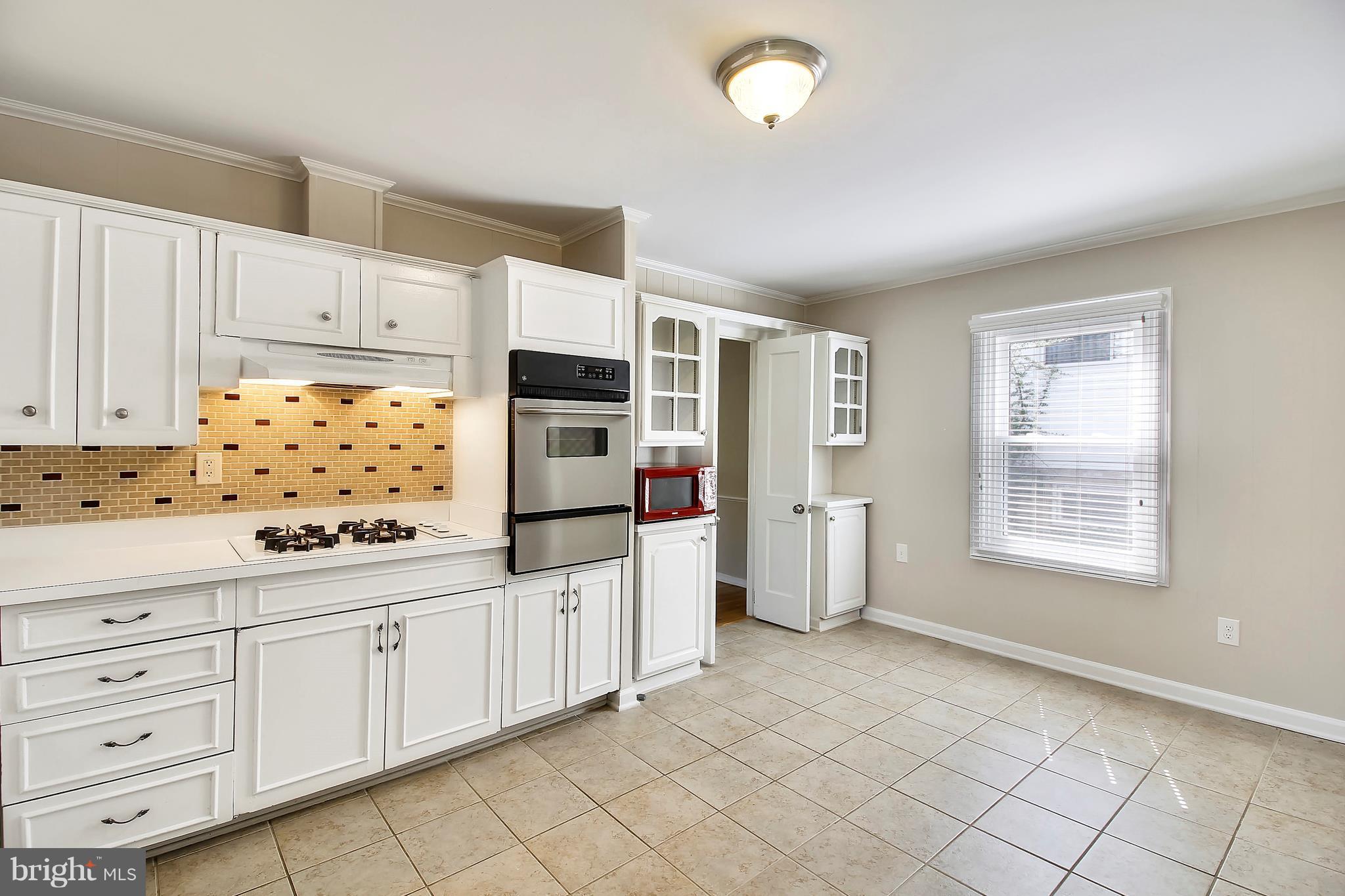 13106 Estelle Road Silver Spring, MD 20906 - Photo 7 of 21 a kitchen with granite countertop white cabinets and white appliances