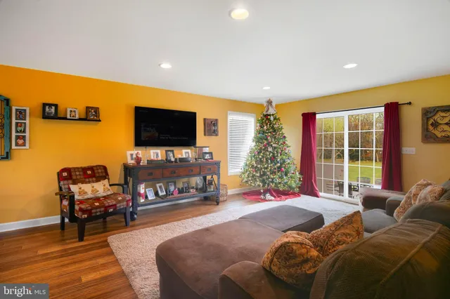 a living room with furniture and a painting on the wall