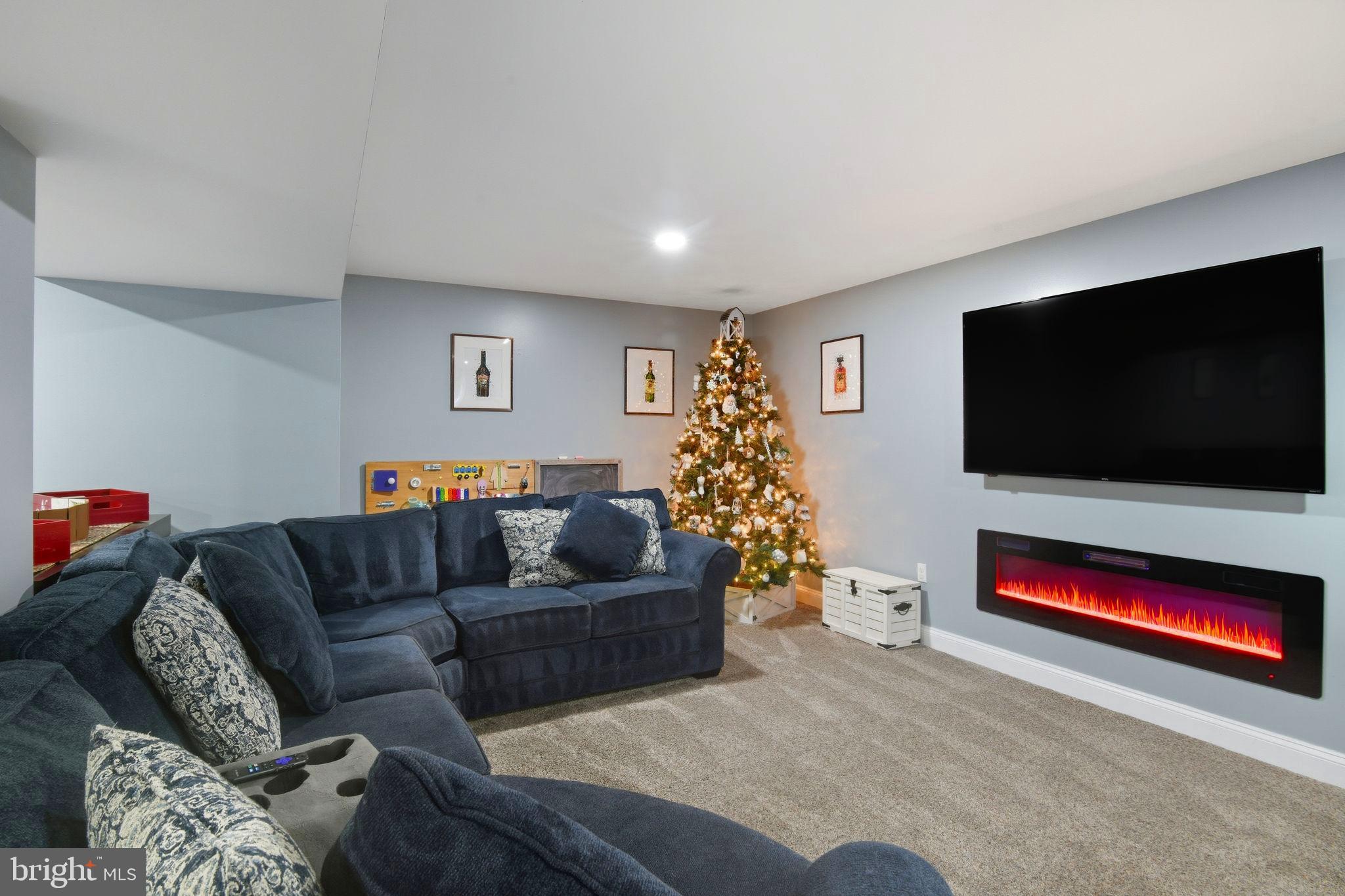 24712 Tribbett Circle Ridgely, MD 21660 - Photo 19 of 37 a living room with furniture and a flat screen tv