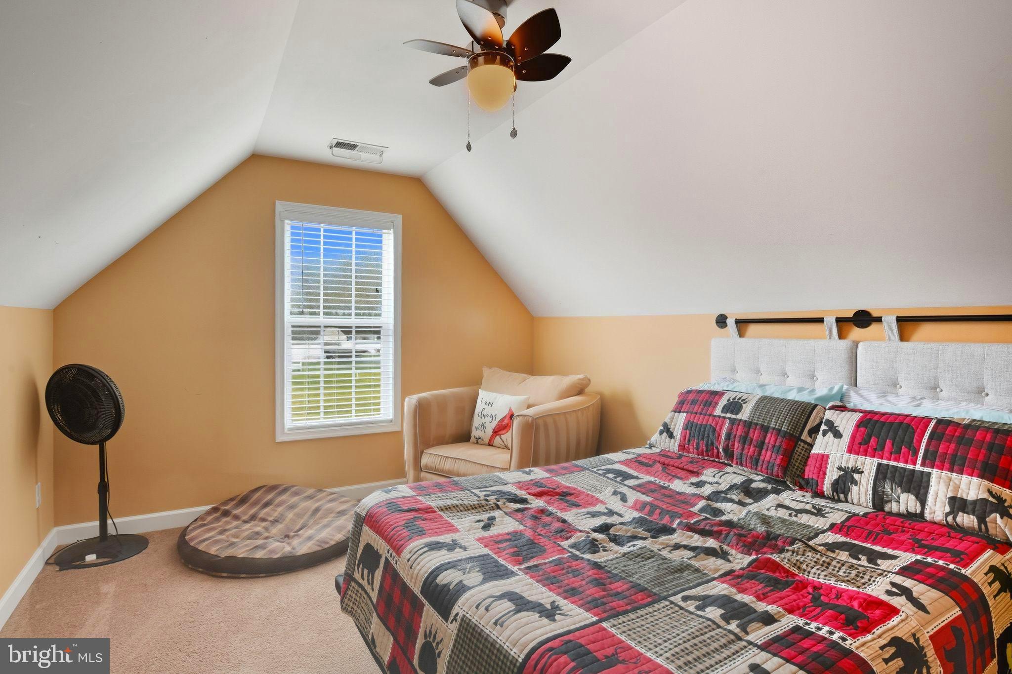 24712 Tribbett Circle Ridgely, MD 21660 - Photo 29 of 37 a bedroom with a bed and a chandelier