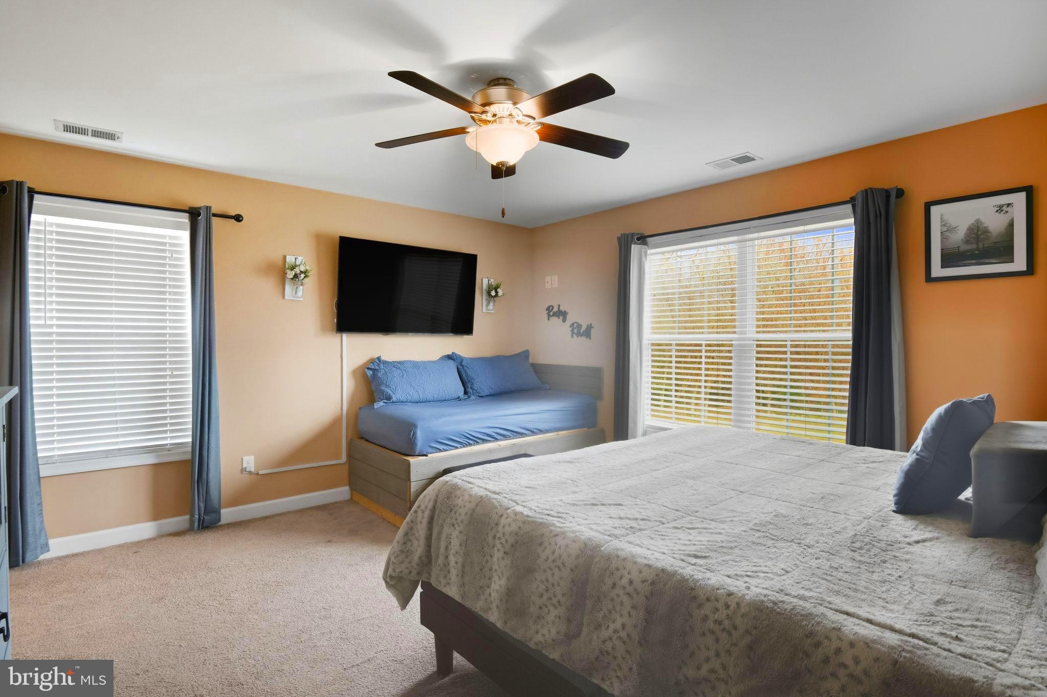 24712 Tribbett Circle Ridgely, MD 21660 - Photo 31 of 37 a bedroom with a bed and a flat screen tv