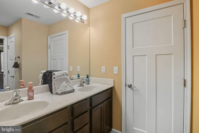 a bathroom with a sink a bath tub and a mirror