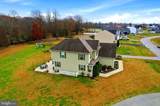 an aerial view of a house with garden space and street view