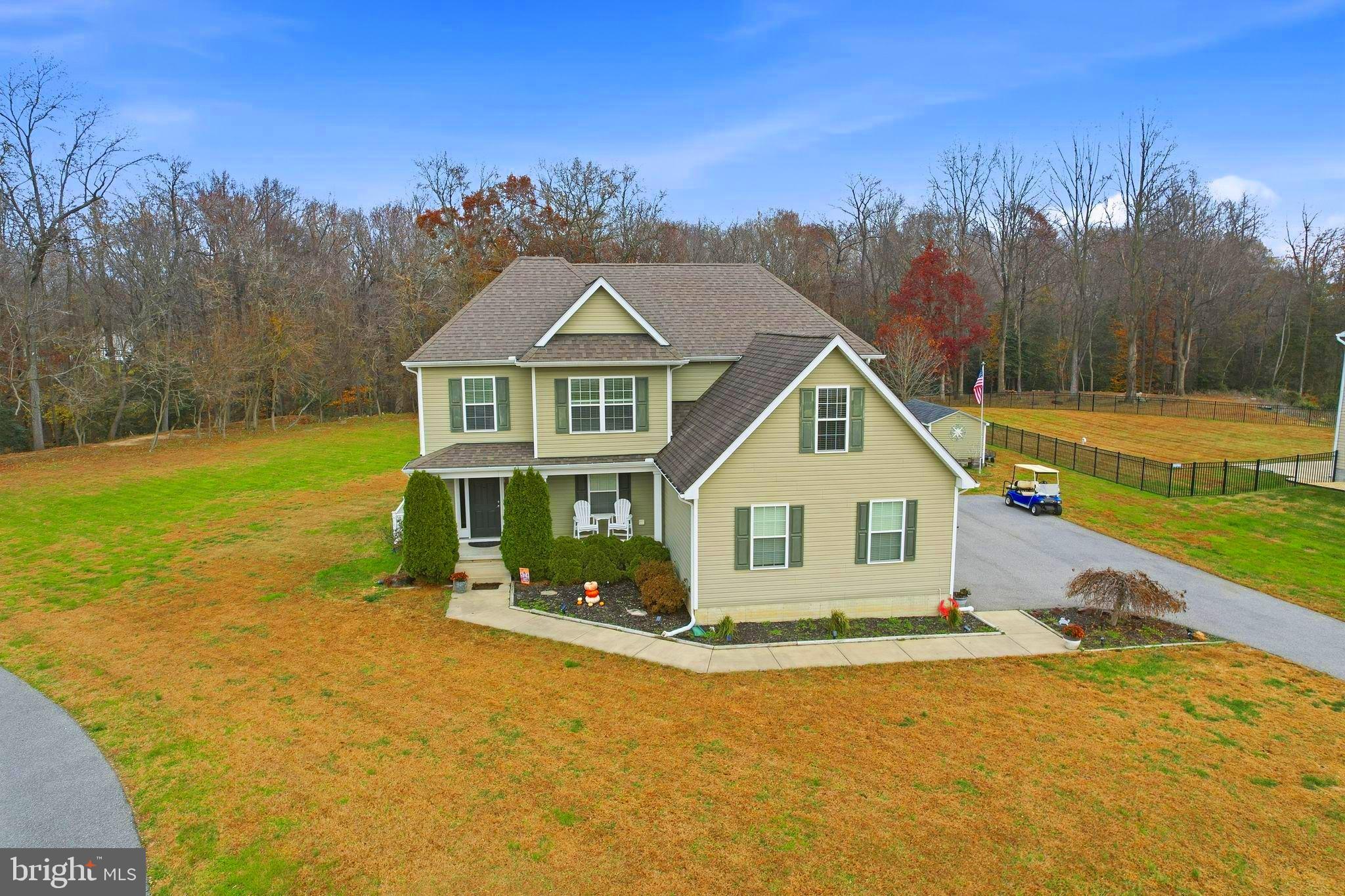 24712 Tribbett Circle Ridgely, MD 21660 - Photo 5 of 37 a front view of a house with a garden and yard
