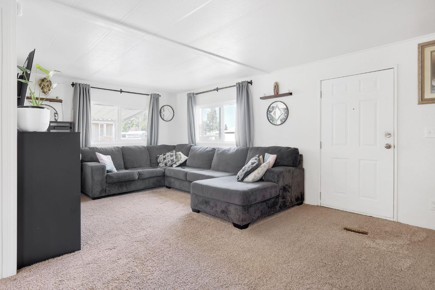 10035 Mills Station Road, Unit 153 Sacramento, CA 95827 - Photo 6 of 23 a living room with furniture and a window