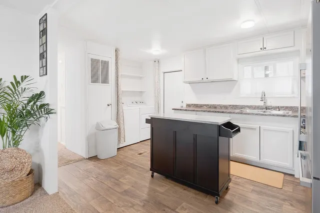a kitchen with stainless steel appliances granite countertop a refrigerator and a sink