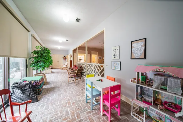 a living room with furniture and a book shelf