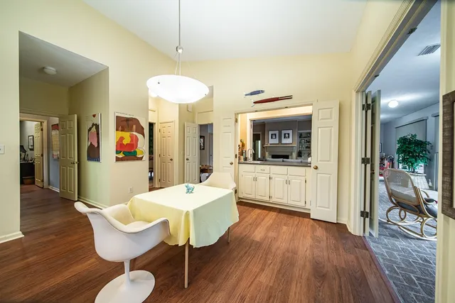 a view of a dining room with furniture and wooden floor
