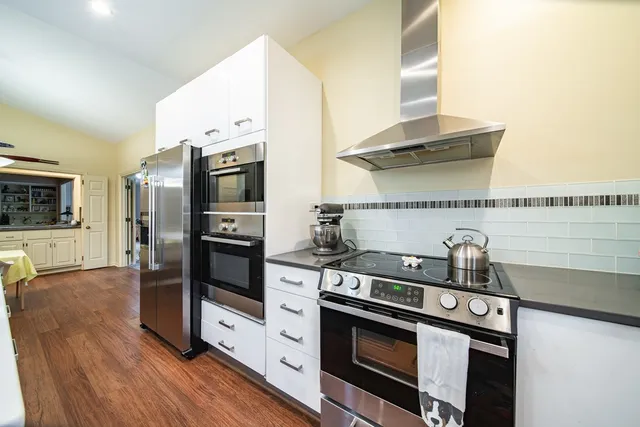 a kitchen with stainless steel appliances a stove and a refrigerator