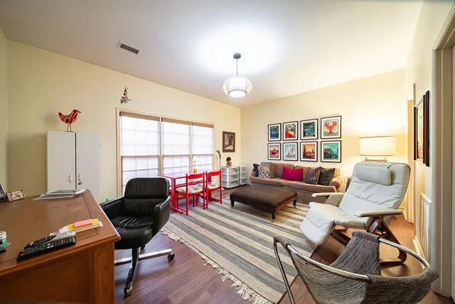 a living room with furniture a air conditioner and a window