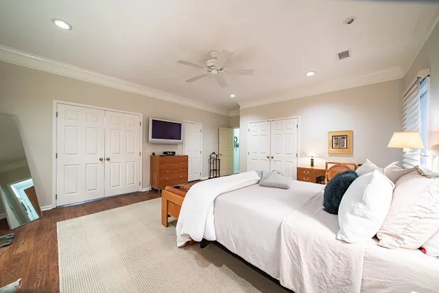 a bedroom with bed and wooden floor