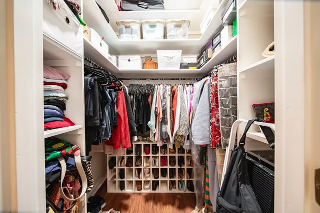 a view of walk in closet with clothes