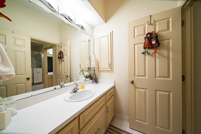 a bathroom with a toilet sink and mirror