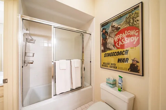 a bathroom with a sink vanity granite tub shower and a mirror