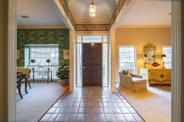 a lobby with furniture and floor to ceiling window